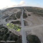 Greenpeace activists from Greece, Italy and Spain spread a 600sqm arrow banner pointing at a Greek oil-fired power plant under construction in the island of Rhodes, to reveal one of the most unacknowledged causes of the Greek crisis; the countrys dependence on imported fossil fuels.